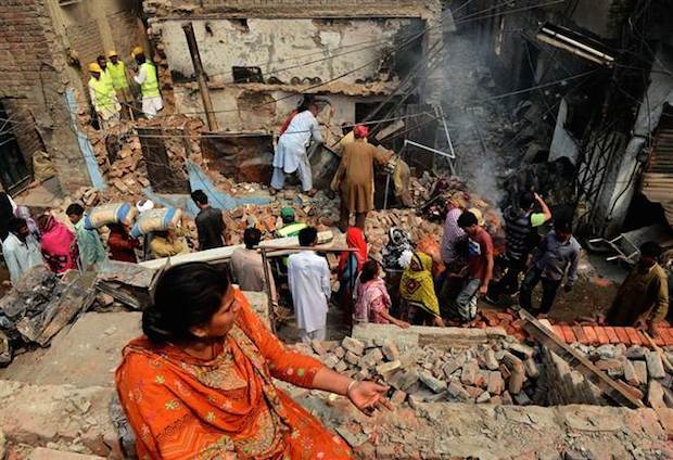 In Pakistan (8 th on the List), a Christian woman observes her destroyed house,