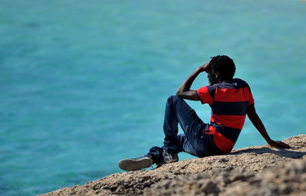 A man looks to the sea in Lampedusa. / Getty,refugee lampesuda sicily