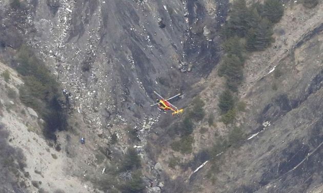  A helicopter hovers above the mountains, on which can be seen countless small pieces of debris / Matrixpictures.co.uk,