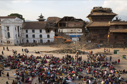 People gather on an open space for security reasons at the Basantapur Durbar Square, damaged in Saturday’s earthquake in Kathmandu. / AP