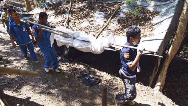 Rescue workers recover human remains from an abandoned camp in Thailand's southern Songkhla. / Reuters,Songkhla