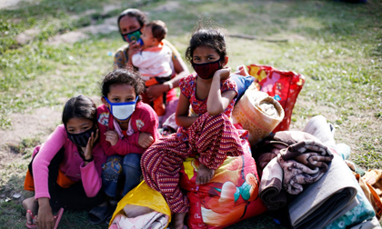 Nepalese girls stay with their belongings on open ground after another earthquake in Kathmandu. /EPA