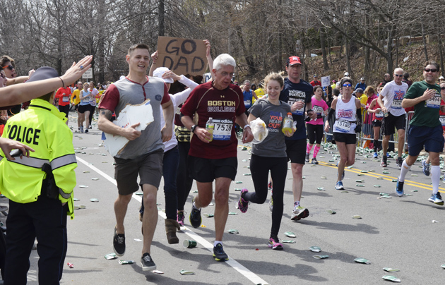 Picture from the Boston race of 2013 in Boston College, 8 km from the end line and some minutes before the bombings. It is tradition for Boston College students to jump in the race and run the last miles with the marathoners. / Photo: Joelle Philippe,