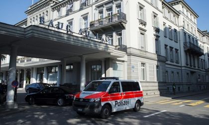 A police vehicle is parked outside of the hotel in Zurich, where the arrests were made /AP