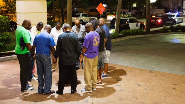 A group of believers pray near Emanuel church in Charleston, after the attack. / AP,charleston, church