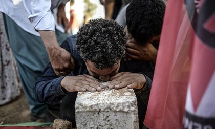 A man mourns during the funeral of victims of the suicide attack in Suruc. / Getty