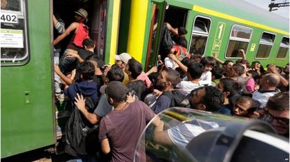 Migrants resisted efforts by police to get them off the train / AFP