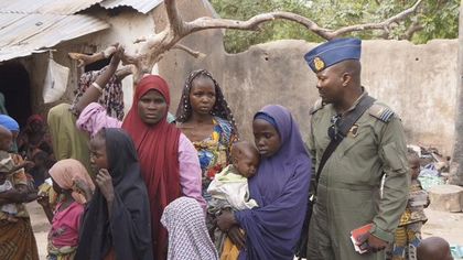 A Nigerian soldier with hostage women and children freed from Boko Haram last April. / Reuters