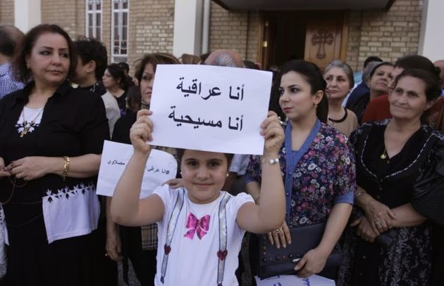  Iraqi girl holds a sign: 'I am Iraqi. I am a Christian.' ,