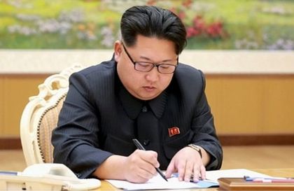 North Korean leader signing the paper to approve the test / Reuters