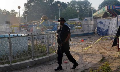 A Pakistani police commando stands guard at a Lahore park following the suicide bombing  / AFP/Getty Images