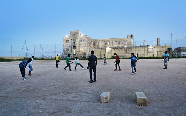 Assylum seekers at Malta's Hal Far Refugee Centre, April 2015. / Photo: Bloomberg. ,