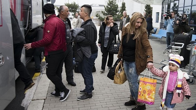 An image of the arrival to the Czech Republic of some of the Christian Iraqi refugees, in February. / Pravo,christian refugees, czech, iraq, controversy, generace 21, generation 21
