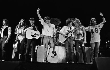 Glenn Frey raises his hand during The Eagles best time in 1979.