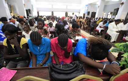 Sudanese Christians pray during Easter Sunday service/ Reuters