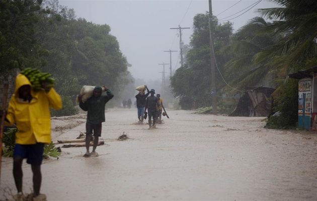 Residents walk in flooded streets as they return to their homes in Leogane, Haiti. /AP,hurrican matthew, haiti