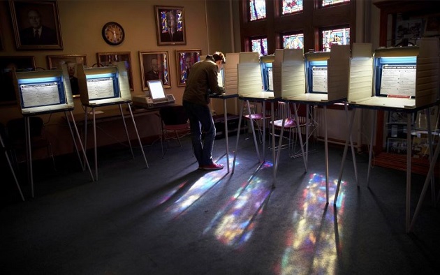 A man votes in a Presbyterian church in Nebraska. / AP,