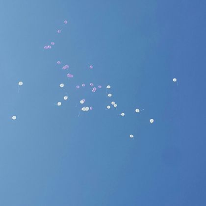 White and purple balloons were released at the end of the event.