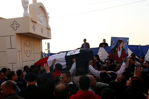 The body of a Christian women killed in the bombing is carried to a cemetery in Cairo on Monday, 12 December. / Reuters,