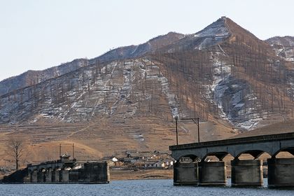 Bridge torn down during the Korean war, in the Yalu River between North Korea and China.