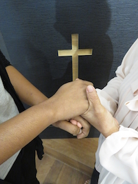 A non-Malay Christian believer with a MBB believer joining hands to support one another.