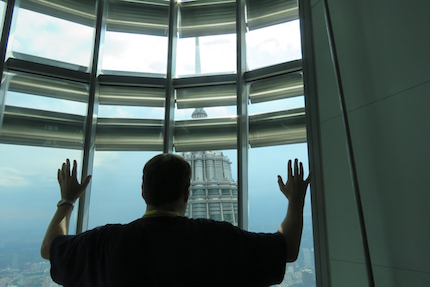 A believer prays from the Petrona Towers in Kuala Lumpur, Malaysia, one of the countries in South East Asia where Malays live.