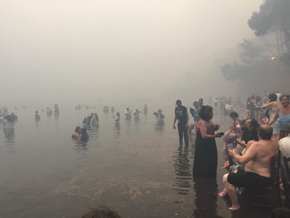 An image of people taking refuge by the sea. / K. Nikos Facebook, via Greece Update