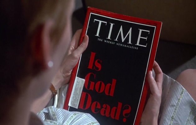 Rosemary looks at the front page of Time magazine. ,