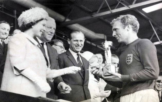 The Queen presenting the 1966 World Cup to the captain of the- English team./ Wikipedia.,