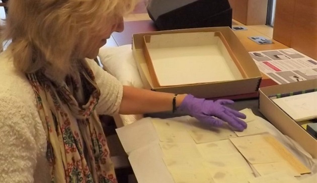 Joan Taylor examining the Dead Sea Scrolls fragments in the John Rylands Library Reading Room. / Photo: Network for the Study of Dispersed Qumran Cave Artefacts and Archival Sources