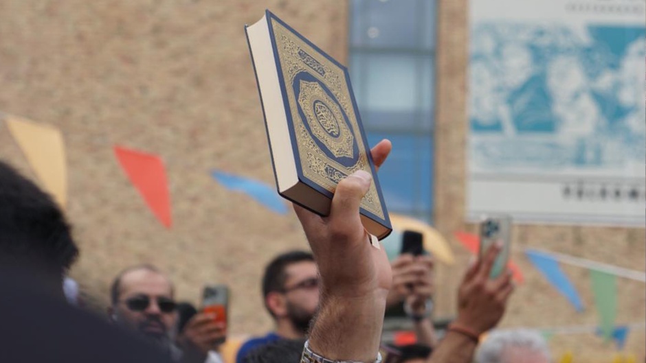 A Quran raised during a protest by Stockholm's Muslim community against the burning of their holy book in July 2023. / Photo: <a target="_blank" href="https://www.facebook.com/sthlmsmoske">Facebook Stockholms Moské</a>.,