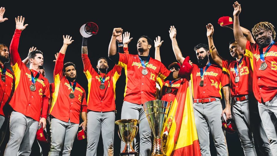 The players raise their hands to give honour and glory to God for their victory. / Grega Valancic. <a target="_blank" href="https://twitter.com/baseballeurope">@baseballeurope</a>.,